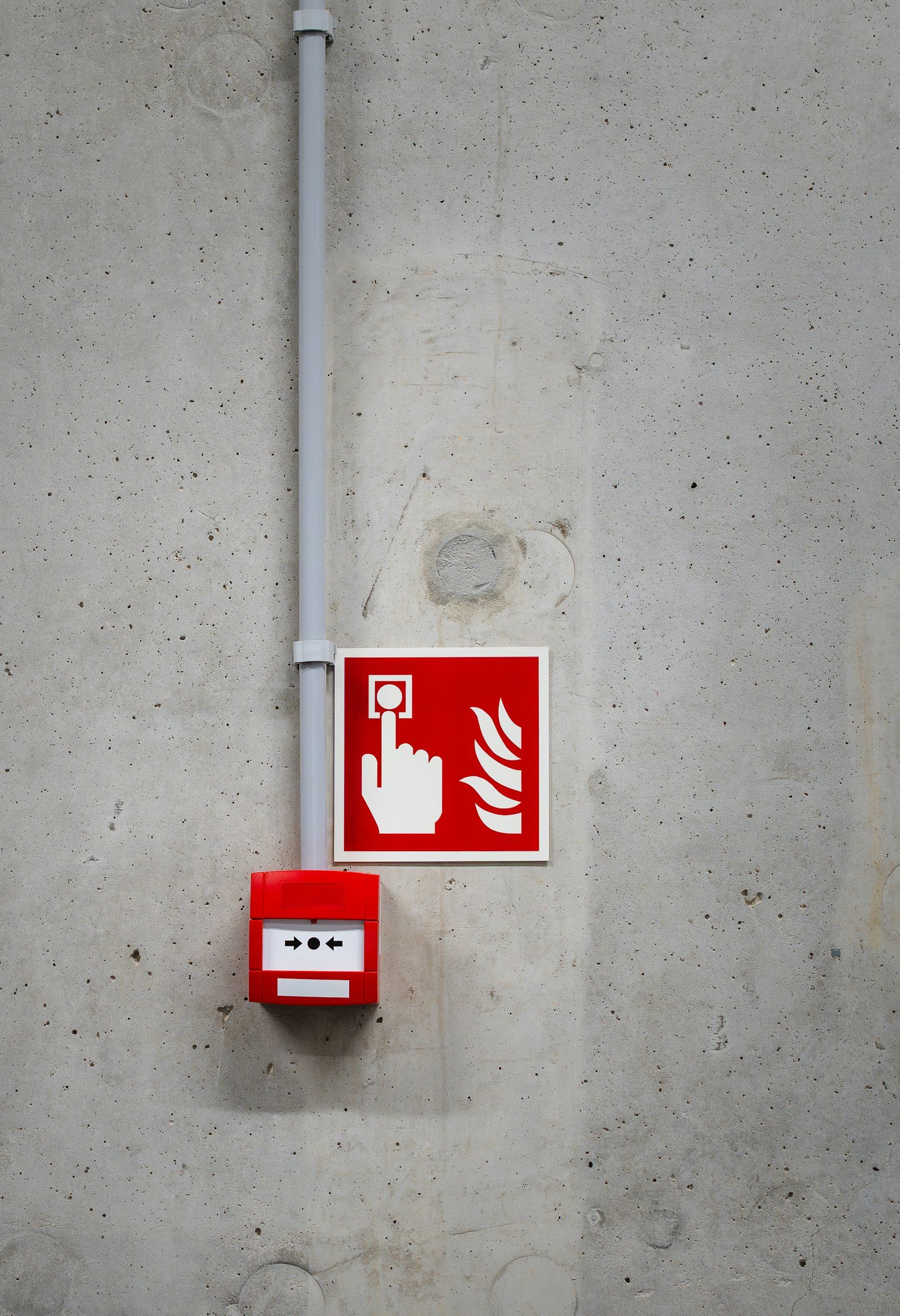 Fire alarm call point on concrete wall